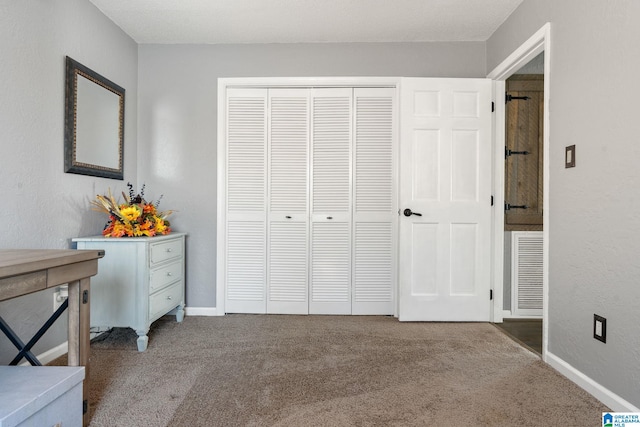 carpeted bedroom featuring a closet