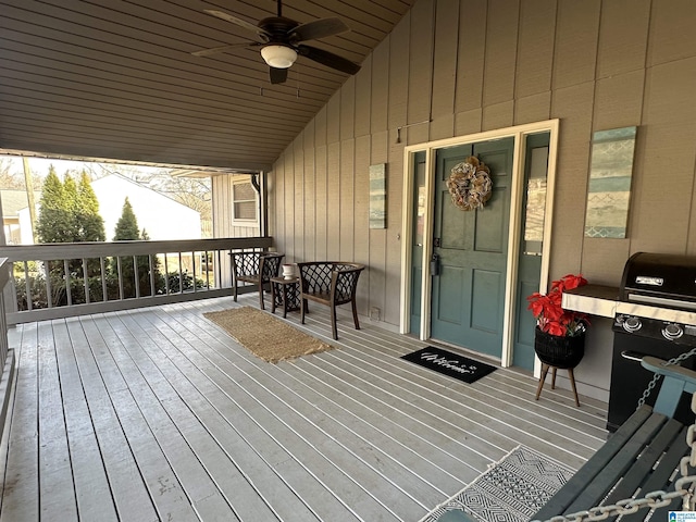 wooden deck featuring ceiling fan and area for grilling