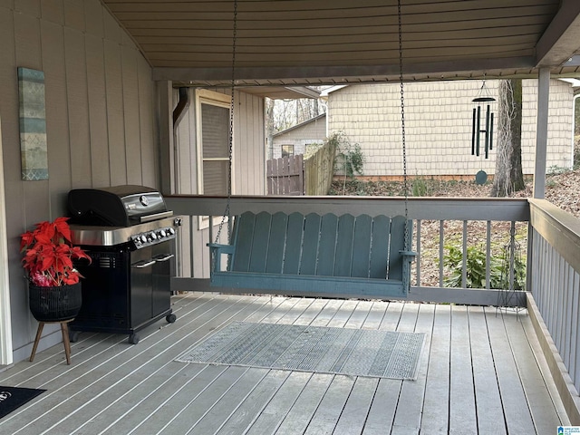 wooden deck with a grill