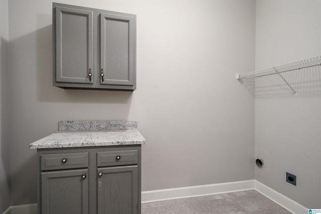 laundry room with cabinets and electric dryer hookup