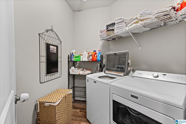 laundry room with washer and clothes dryer and dark hardwood / wood-style floors