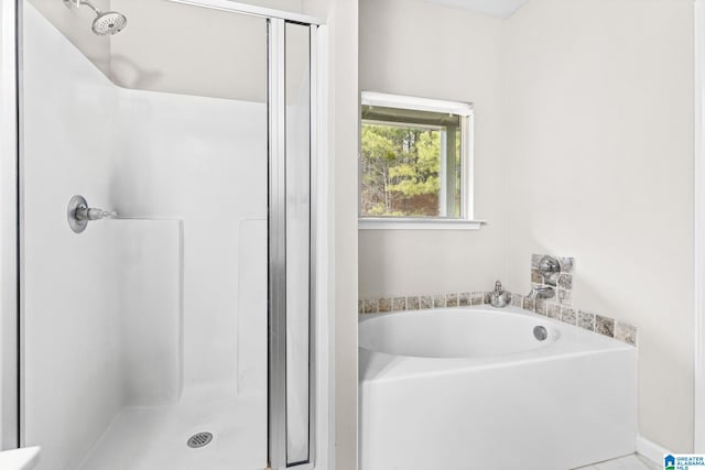 bathroom with separate shower and tub