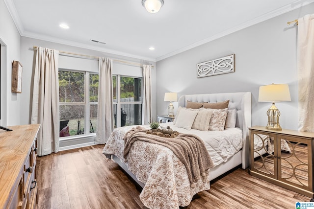 bedroom featuring crown molding and wood-type flooring