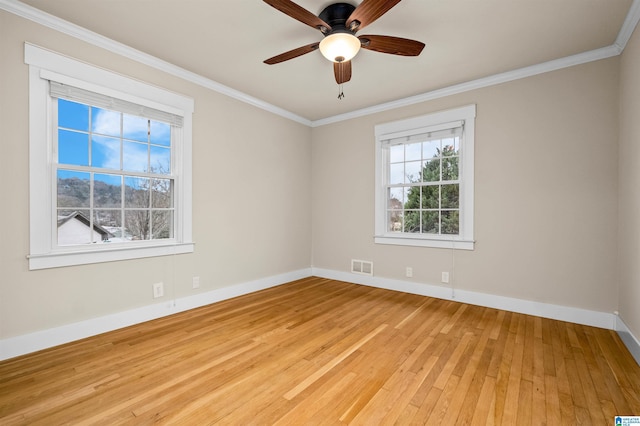 empty room with ceiling fan, crown molding, and light hardwood / wood-style flooring