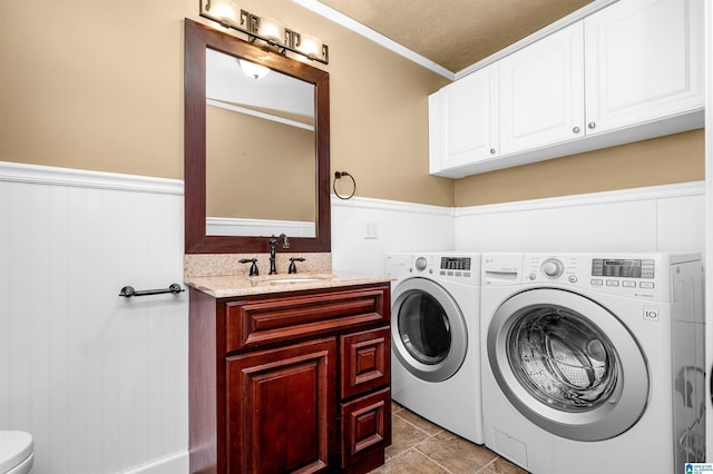 washroom featuring sink, washer and clothes dryer, ornamental molding, and light tile patterned flooring