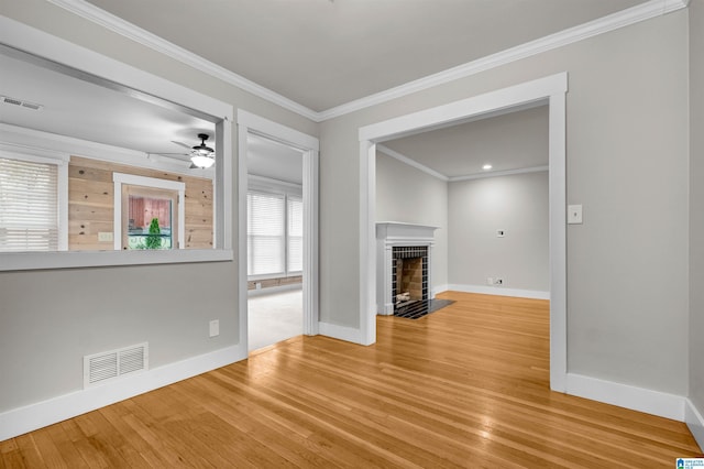 unfurnished living room with ceiling fan, ornamental molding, and hardwood / wood-style flooring