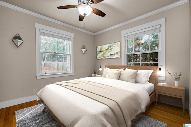 bedroom with ceiling fan, hardwood / wood-style floors, and crown molding