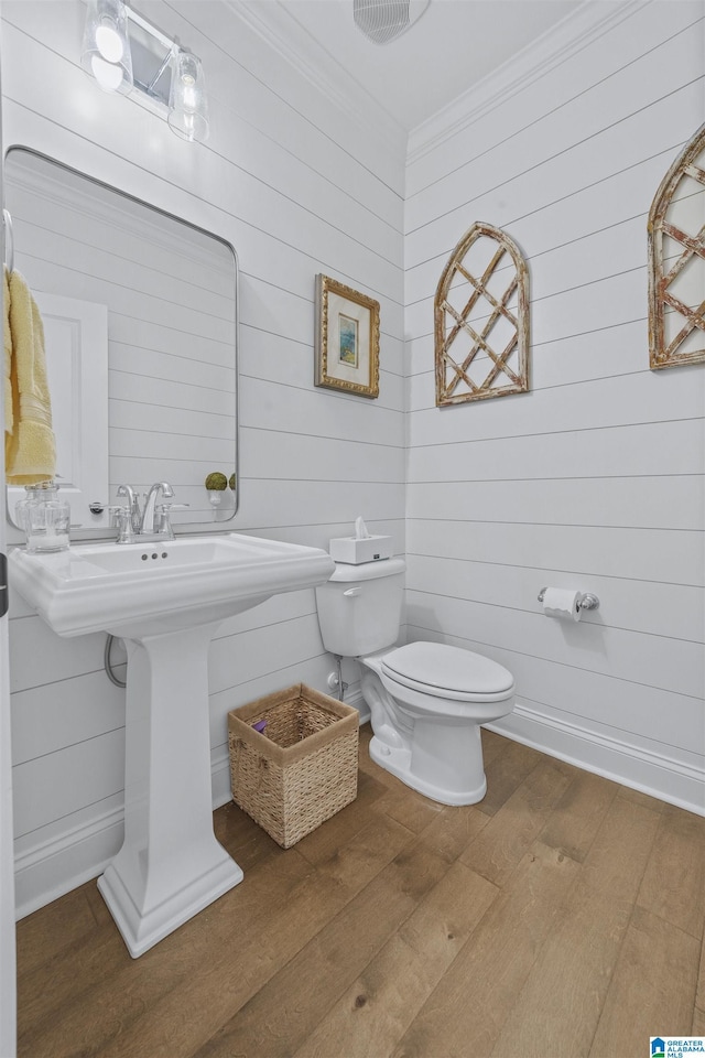 bathroom with hardwood / wood-style floors and toilet