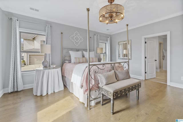 bedroom with hardwood / wood-style floors and crown molding