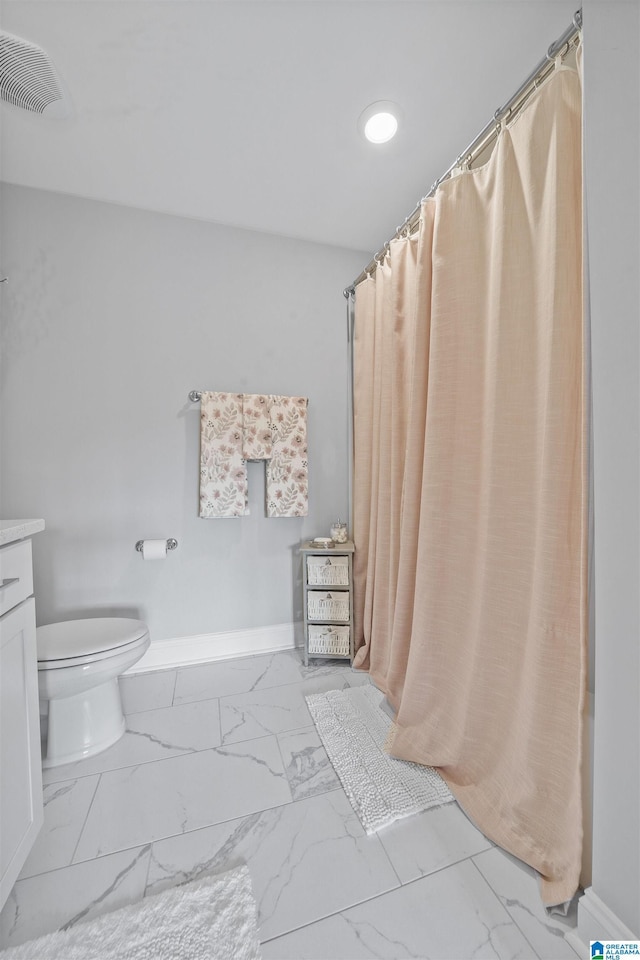 bathroom with toilet and vanity