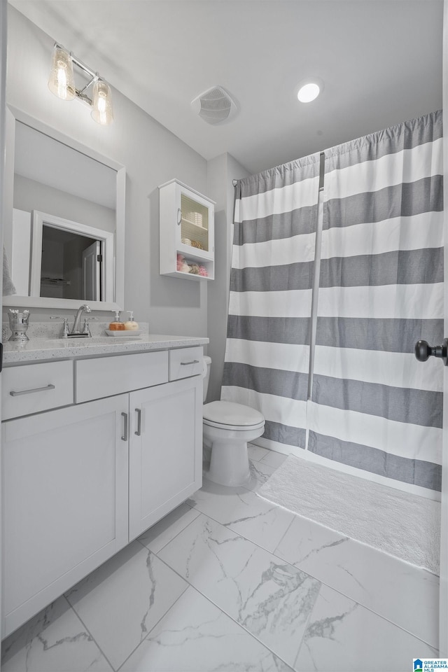 bathroom featuring toilet and vanity