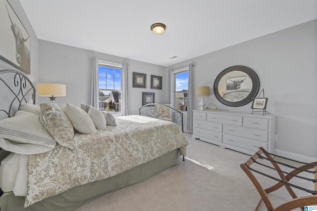 bedroom featuring light carpet