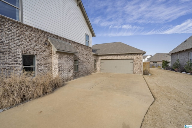 view of side of home featuring a garage