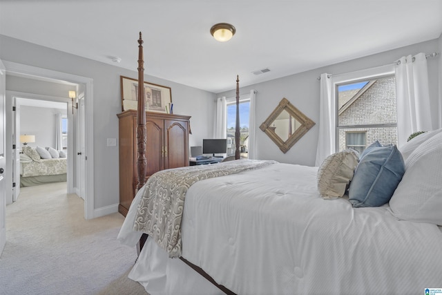 carpeted bedroom featuring multiple windows