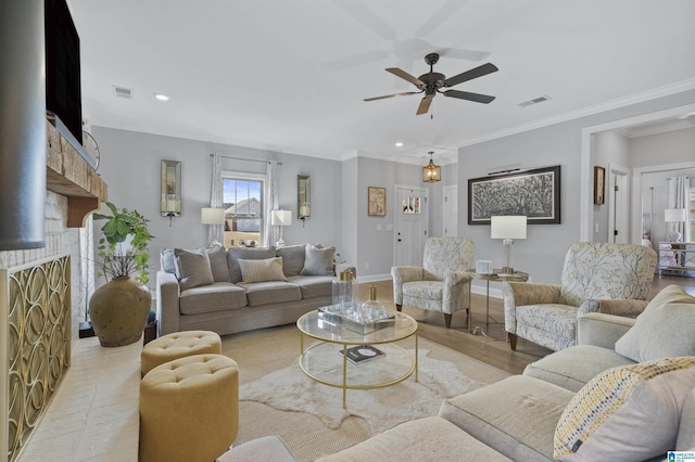 living room featuring ceiling fan and crown molding