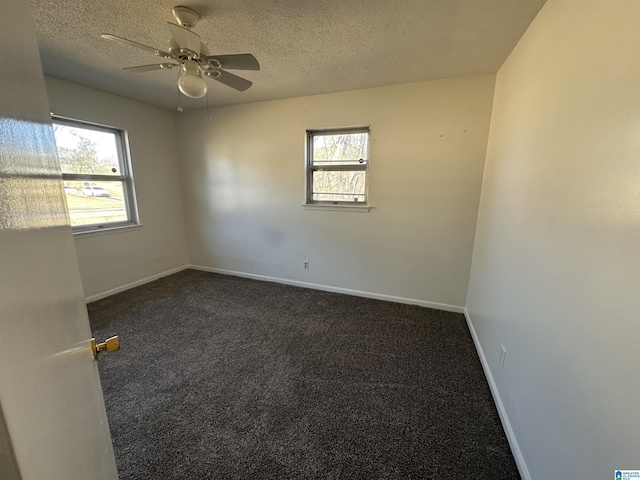 carpeted empty room with a textured ceiling and ceiling fan