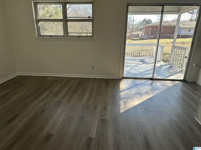 unfurnished room with dark hardwood / wood-style floors