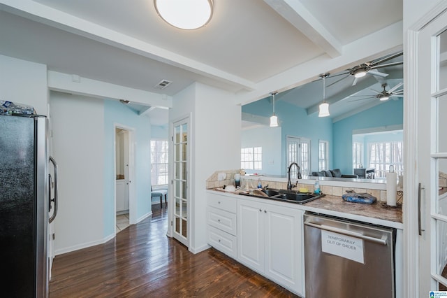 kitchen with sink, decorative light fixtures, a healthy amount of sunlight, lofted ceiling with beams, and appliances with stainless steel finishes