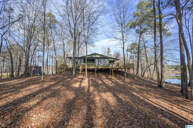 exterior space featuring a deck with water view