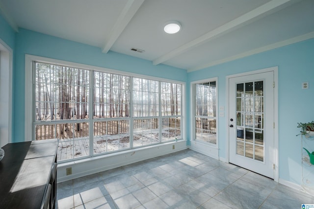 unfurnished sunroom featuring a wealth of natural light and beamed ceiling