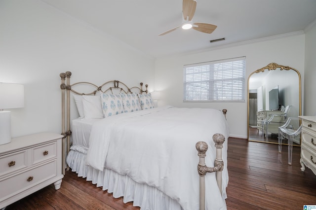 bedroom with ceiling fan, dark hardwood / wood-style floors, and crown molding