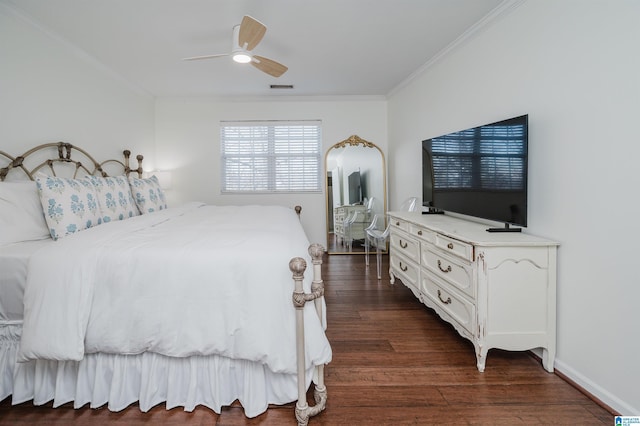 bedroom featuring ceiling fan, dark hardwood / wood-style flooring, and crown molding