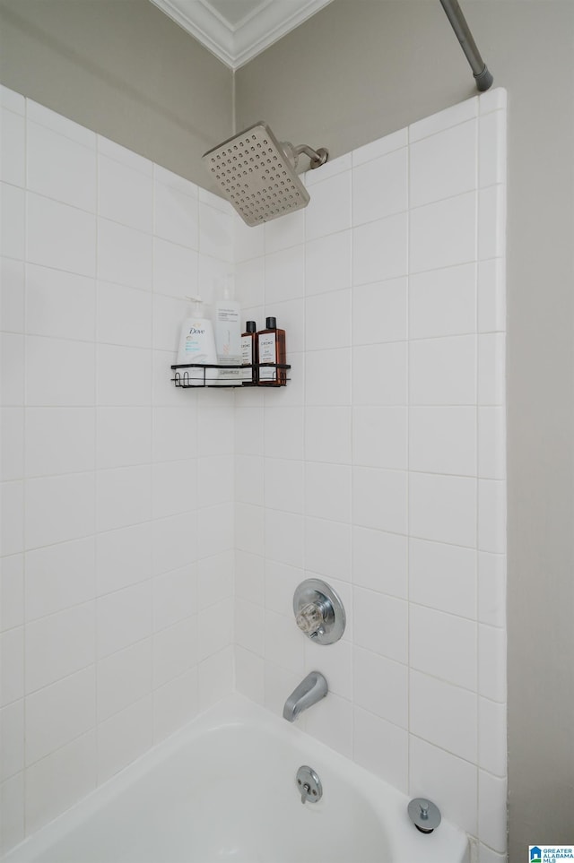 bathroom with bathtub / shower combination and ornamental molding