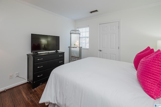 bedroom featuring dark hardwood / wood-style flooring and crown molding