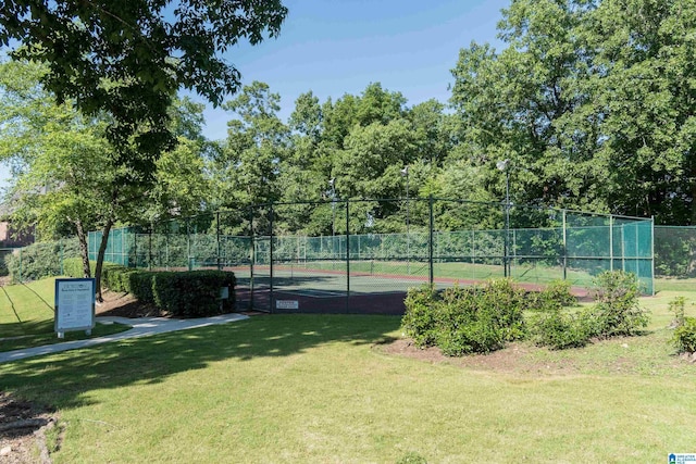 view of sport court featuring a yard