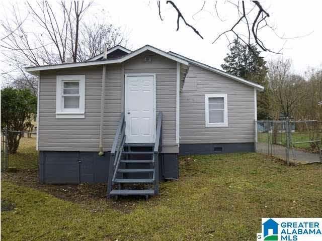 rear view of house with a yard