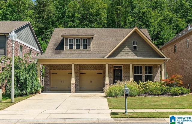 craftsman-style house featuring a front yard and a garage