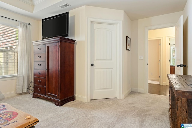 bedroom with light carpet and crown molding