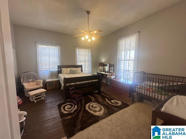 bedroom featuring a crib and ceiling fan