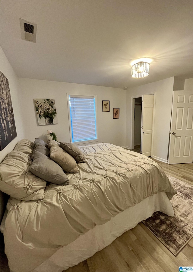 bedroom with hardwood / wood-style flooring