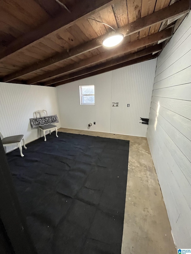 bonus room featuring vaulted ceiling with beams, concrete flooring, wood walls, and wooden ceiling