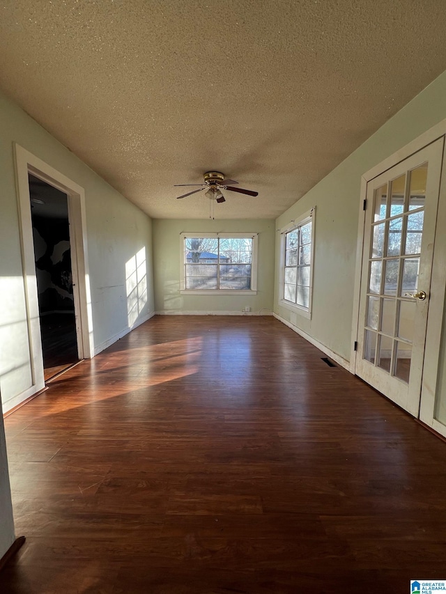 unfurnished sunroom with ceiling fan