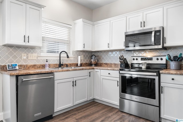 kitchen with sink, white cabinets, stainless steel appliances, and dark hardwood / wood-style floors