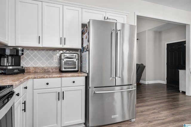 kitchen with backsplash, white cabinetry, dark hardwood / wood-style flooring, and stainless steel appliances