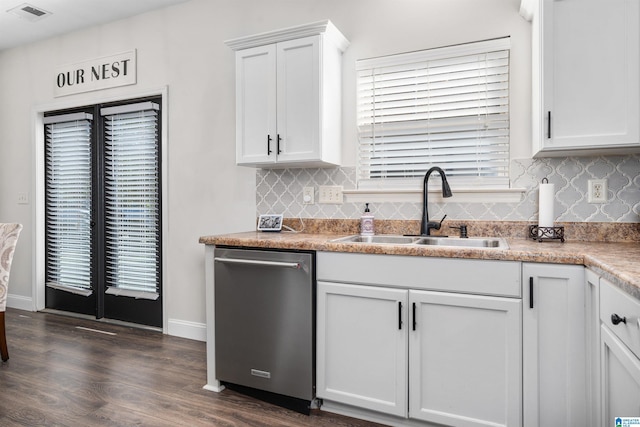 kitchen featuring dark hardwood / wood-style flooring, stainless steel dishwasher, sink, white cabinets, and plenty of natural light