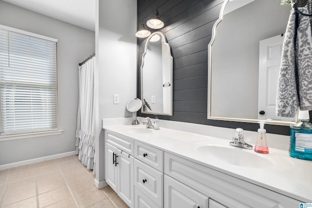 bathroom with wooden walls, tile patterned flooring, and vanity