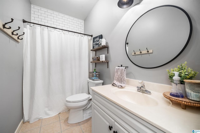 bathroom featuring tile patterned floors, vanity, and toilet