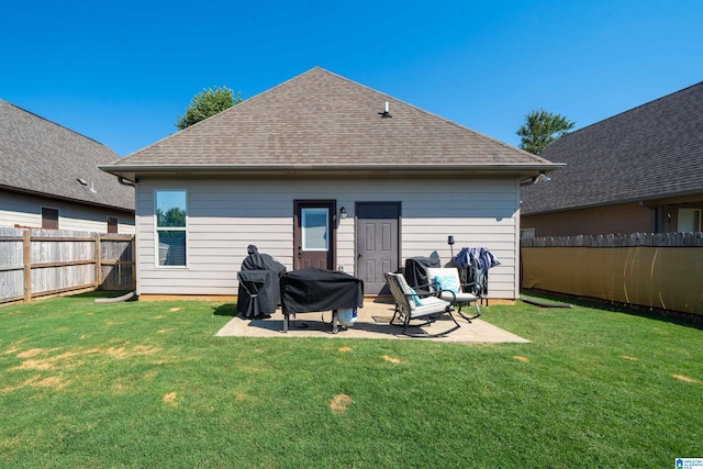 back of house featuring a yard and a patio