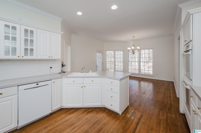 kitchen featuring kitchen peninsula, white cabinets, sink, and white dishwasher