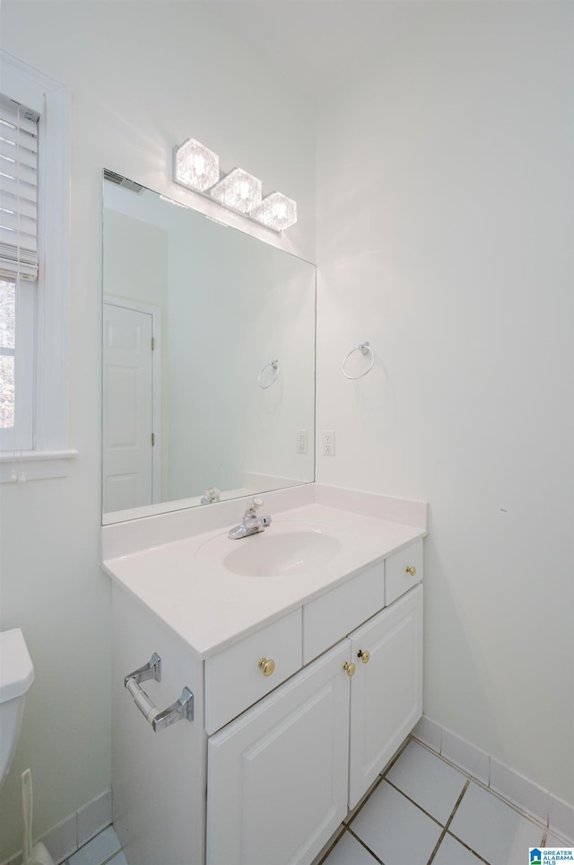 bathroom featuring toilet, vanity, and tile patterned floors