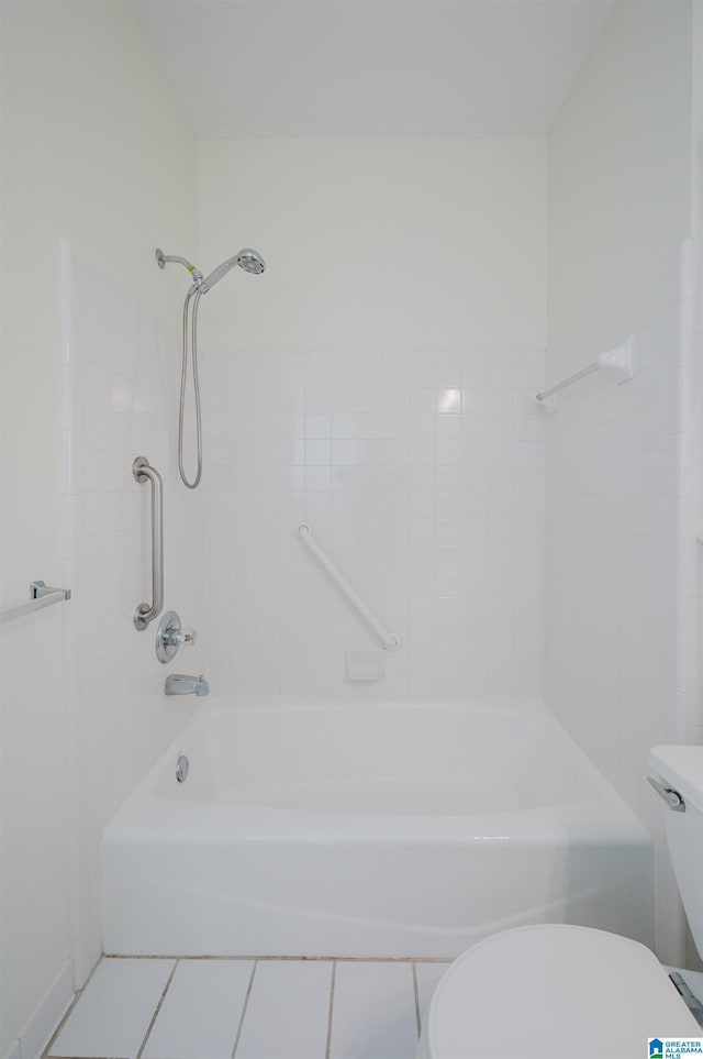 bathroom with tile patterned floors, toilet, and tub / shower combination