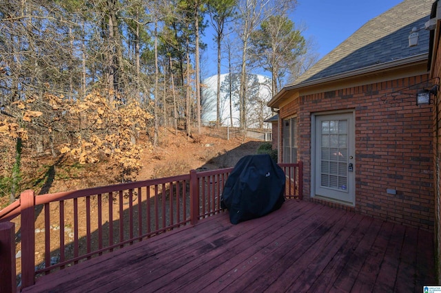 wooden deck with a grill