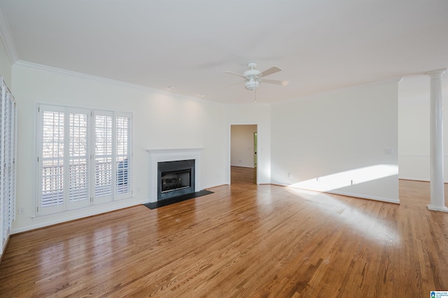 unfurnished living room with ceiling fan, light wood-type flooring, and ornamental molding