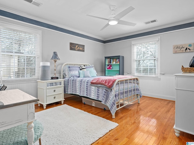 bedroom with ceiling fan, ornamental molding, and light hardwood / wood-style flooring