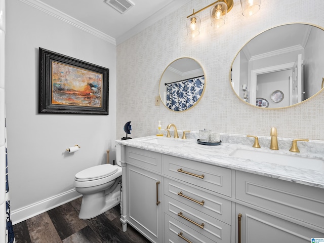 bathroom featuring toilet, crown molding, wood-type flooring, and vanity