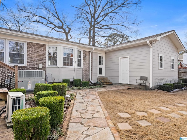 rear view of property with ac unit